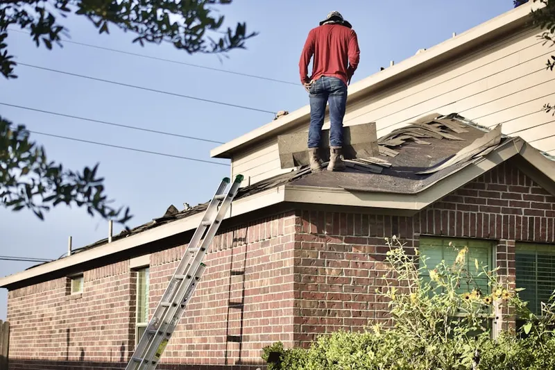 Professional roofer working on a residential roof in Red Rock